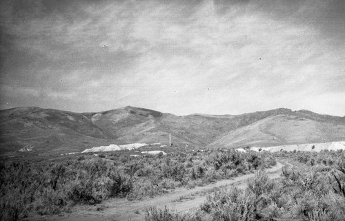 Dumps, chimney, and union mill in distance, Tuscarora, Nevada, SV-621