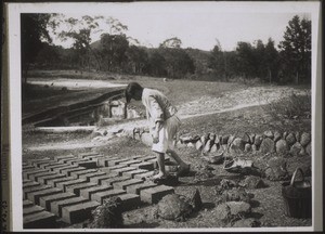 A farmer preparing bricks of clay. In poorer regions the houses are built of clay bricks