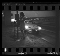 Woman using a freeway emergency telephone in Los Angeles, Calif., 1970