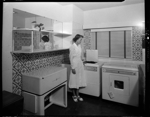 Woman with electric washer and dryier