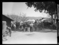Men standing outside tents in the days following the failure of the Saint Francis Dam and resulting flood, Bardsdale (Calif.), 1928
