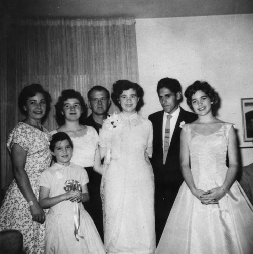 Mexican American groom with bride and family