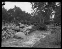 Flood waters flow past debris in Little Santa Anita Canyon, Sierra Madre, 1926