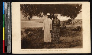 Husband and wife stand posed outside, Lokandu, Congo, ca.1920-1940