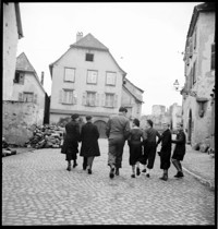 [Miscellaneous People: a few boys and adults on a village street, Ammerschwihr, showing some war damage]