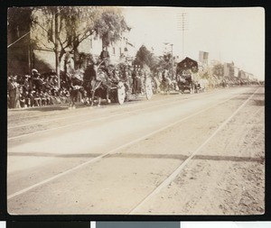 Parade with floats and flags flying, ca.1920
