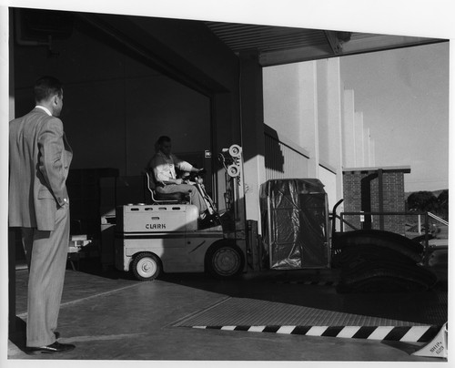 Boxed IBM Data Processing Machines Being Forklifted Onto a Loading Dock