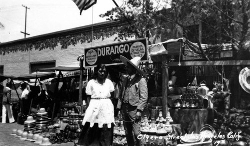 Man and woman at vending booth, Olvera Street