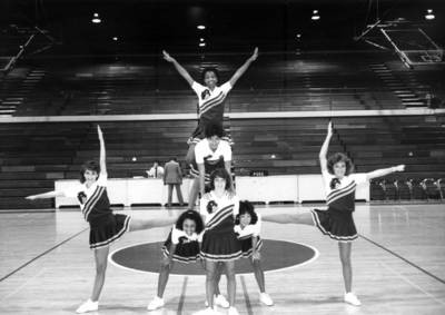 Cheerleaders form a stack in the gym, Chapman College, Orange, California, 1985
