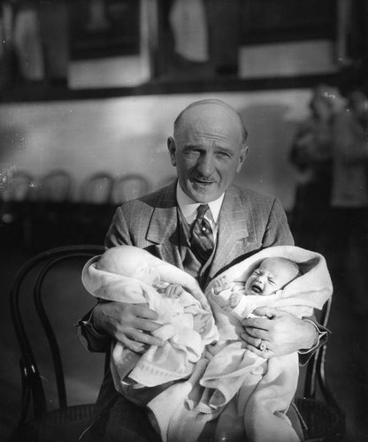 Man holding babies