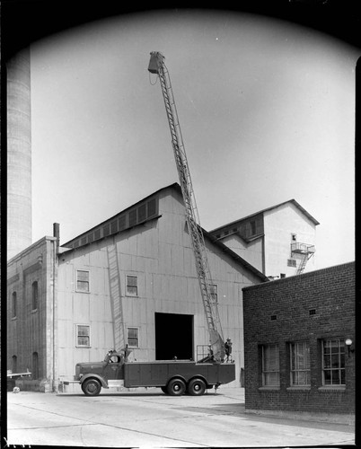 Edison bucket truck with bucket raised and extended to maximum height
