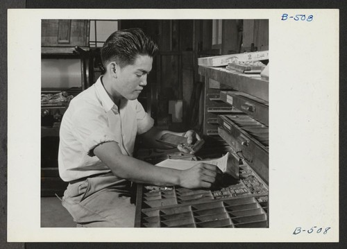 Roy Sugiura, former student of printing at the Roosevelt High School in Los Angeles, is shown hand-setting type which will