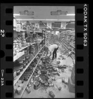 Worker cleaning up Vons store after earthquake in Desert Hot Springs, Calif., 1986