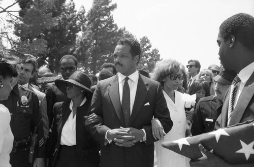 Jesse Jackson walking with Altovise Davis (right) and Cicely Tyson at Sammy Davis Jr.'s funeral service, Glendale, California, 1990