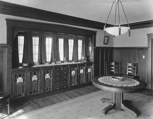 Dining room with cabinets along wall, and table in center of room