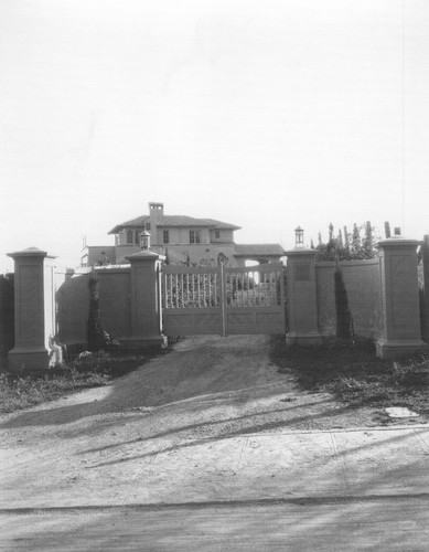 Front gates of Wilson residence, with view of house behind them