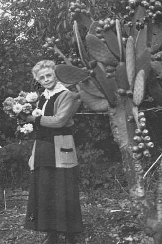 Florence Watkins Hill standing next to a cactus plant in the yard