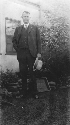 Andrew P. Hill, Jr. standing in the yard at his home