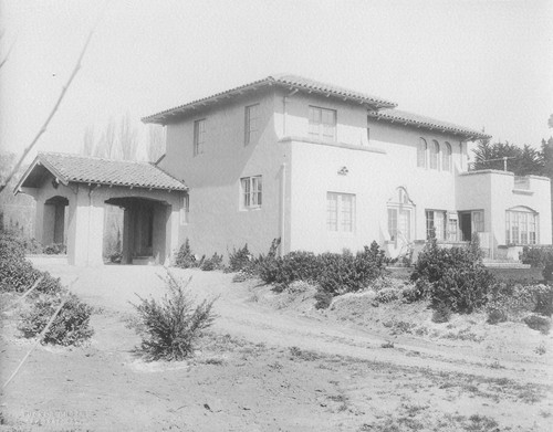 Rear view of Wilson house with porte cochere and view of garden