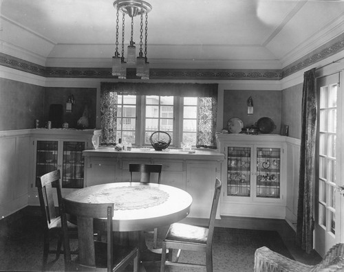 View of dining room with table and chairs, built-in cabinets