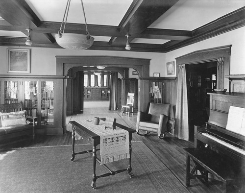 View of living room with piano and table in center