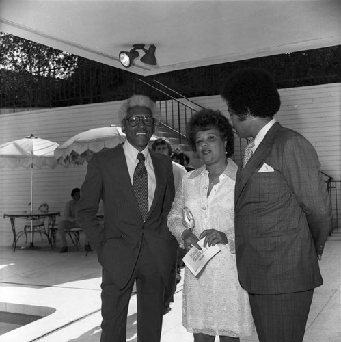 Bayard Rustin, Gwen Green, and Ken Orduna talking together, Los Angeles, 1973