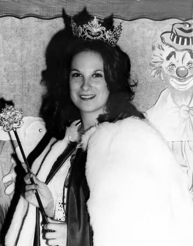 A crowned woman participating in Mardi Gras — Calisphere