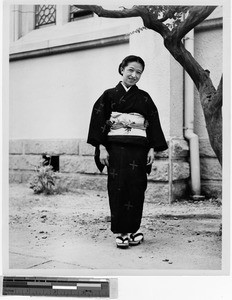 Portrait of a Japanese woman wearing a kimono and geta sandals, Kyoto, Japan, ca. 1949