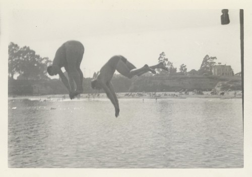 Unidentified men diving off wharf