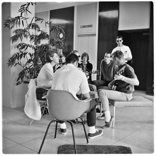 Students playing music in lobby of Urey Hall