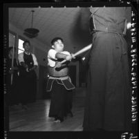 Brian Togohata puffs hard during Kendo practice session with Torao Mori in Lawndale, Calif., 1958