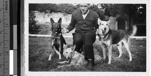Maryknoll Priest and three dogs, Loting, China, ca. 1936