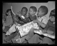Five boys opening Christmas presents at Ninth Street School in Los Angeles, Calif., 1947