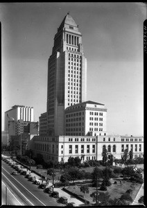 Exterior view of Los Angeles City Hall with a park in the foreground, ca.1928