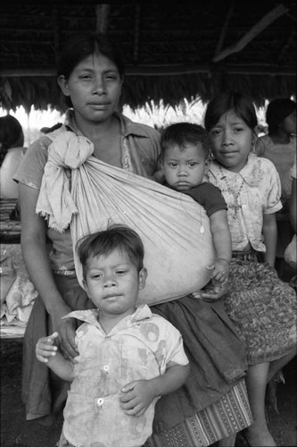 Refugee woman carries a small boy, Chiapas, 1983