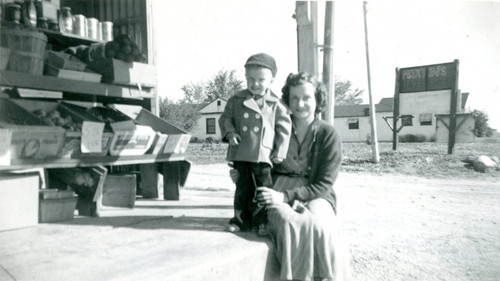 Irene Embshoff and her son, Hal, posing in front of their fruit and vegetable store called Hal's Date Shop at 1865 W. Ramsey Street in Banning, California