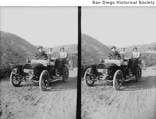 Stereoview of three women in a Franklin automobile on the Mesa Grade in the mountains