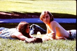 Unidentified young woman and young man lying on a lawn