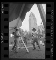 Workers setting up tent for the homeless Tent City, across the street from City Hall in Los Angeles, Calif., 1984
