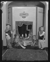 Children at a Halloween party playing with puppets, Los Angeles, 1935