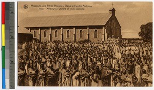 Missionary father assembling with others before a brick church, Tanganyika, ca.1920-1940