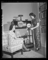 Mrs.Quon shows art object at spring festival and bazaar of the Los Angeles Chinese Woman's Club, 1949