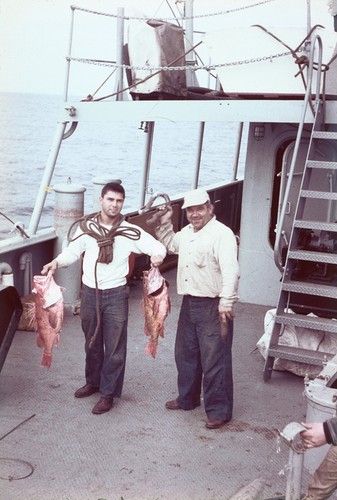 Two members of the crew showing off their fishing catch on the deck of R/V Horizon during the MidPac expedition. 1950
