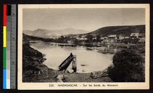 Two dugout boats floating near a village, Madagascar, ca.1920-1940