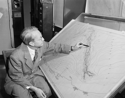 Francis Parker Shepard in his office at the Scripps Institution of Oceanography. Shepard was an American sedimentologist most associated with his studies of submarine canyons and seafloor currents around continental shelves and slopes. He focused on the shelves off California and the Gulf of California, and the processes that shaped them. Submarine canyons, he suggested, were initially carved by rivers when sea levels were lower during the recent Pleistocene epoch. Shepard received both the Wollaston Medal from the Geological Society of London (1966) and the Sorby Medal from the International Association of Sedimentologists (1978)