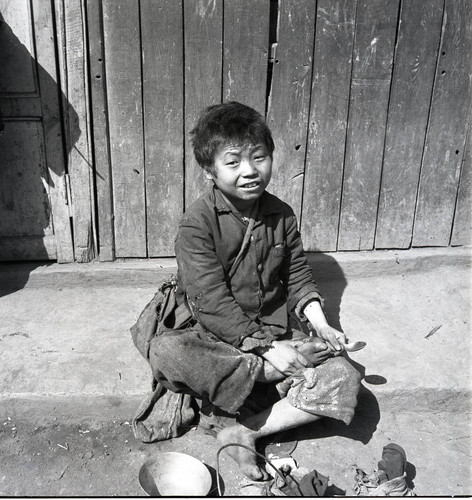 Street kid sitting on the curb