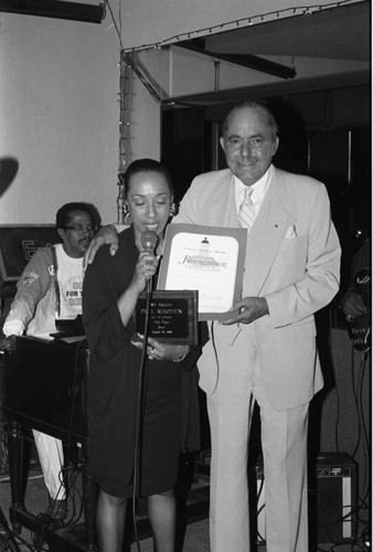 Reve Gipson presenting an award to Phil Rhoten at the Pied Piper nightclub, Los Angeles, 1989