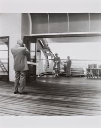 Bonnie and Bill Alwes, and George Dodds on the deck of a ship bound for Scotland, 1955