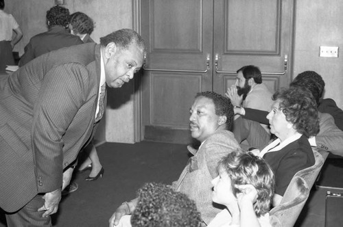 Paul Winfield talking with others during a meeting on homelessness, Los Angeles, 1986