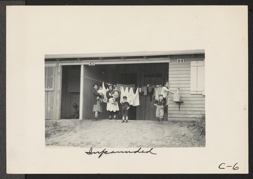 Evacuee mothers, with their children, getting acquainted at the Santa Anita Center, where evacuees from this area are awaiting transfer to War Relocation Authority center to spend the duration. Photographer: Albers, Clem Arcadia, California
